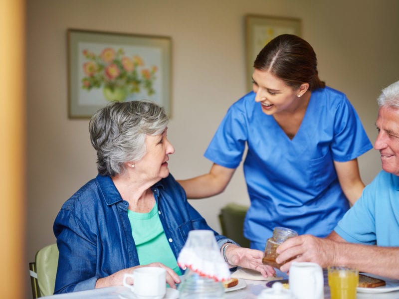 An assisted living aide checks on a resident who may need their help.