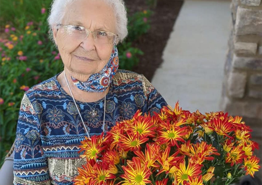 nior citizen woman with flowers in an assisted living facility