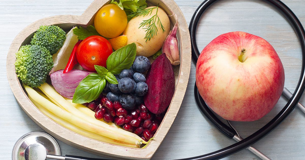 Foods that promote healing after surgery in a heart-shaped bowl with a stethoscope.